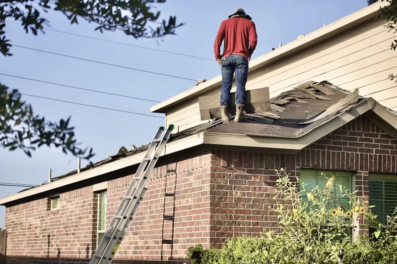 Professional roofer working on a residential roof in Penn Quarter